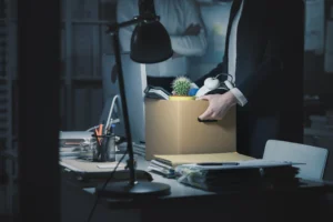 An employee packing up a box of his things. 