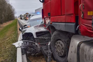 A truck and car involved in an accident on a highway.